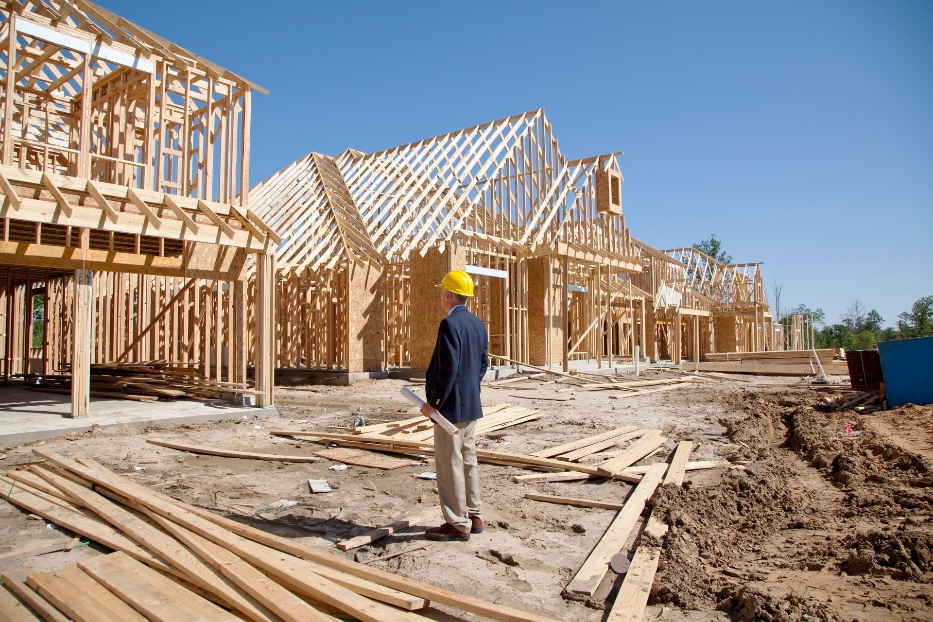 New homes construction site with contractor in foreground